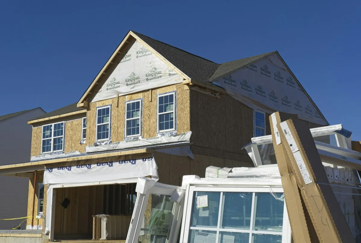 House under construction with roof framing exposed