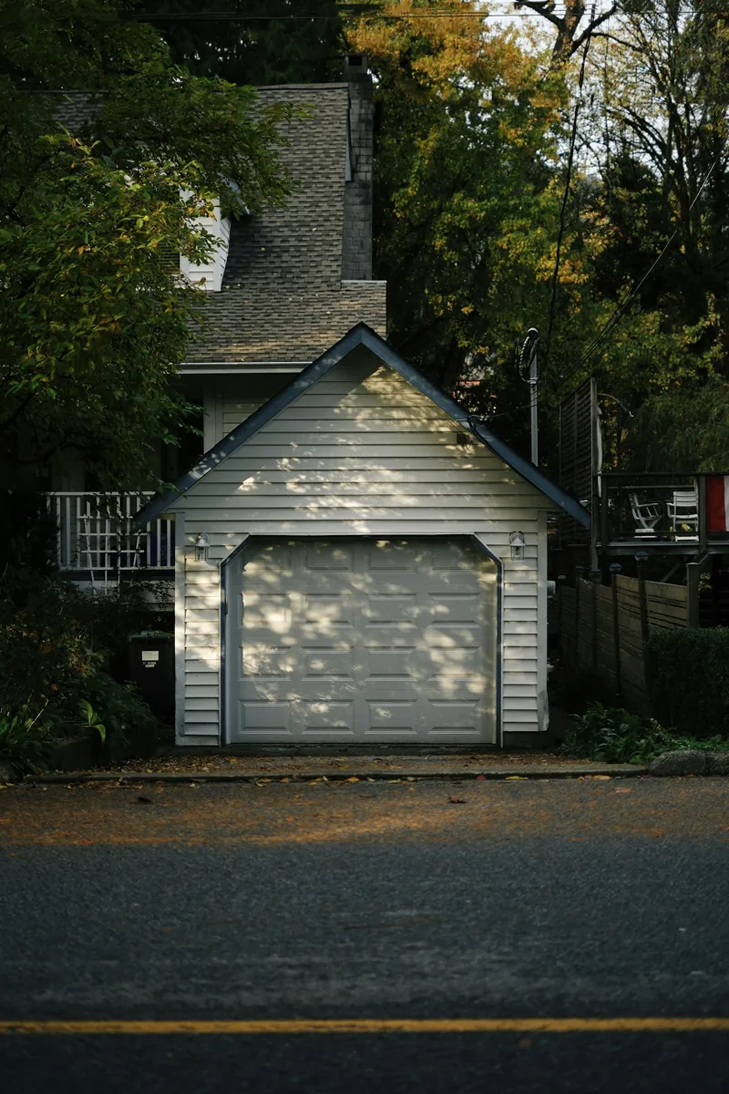 Detached one-car garage in front of a house