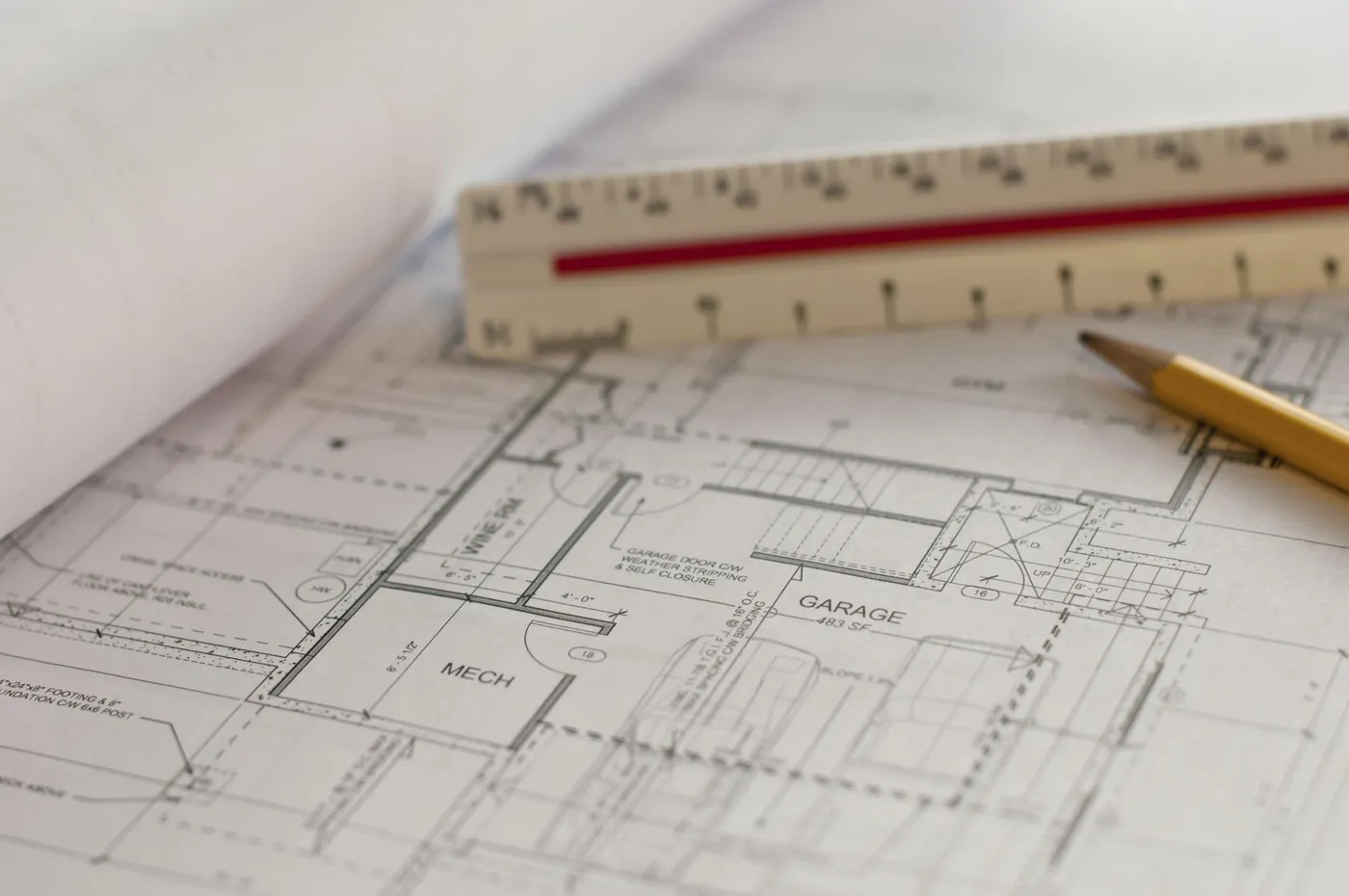 Floor plan drawing with an architect's scale and pencil