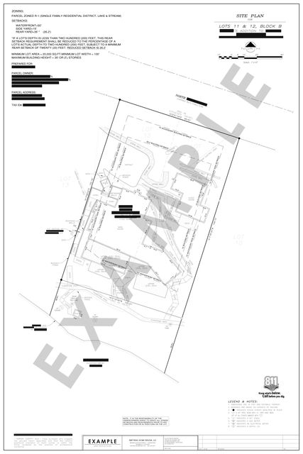 Waterfront site plan: Main house, guest house, stone walls, and a reduced rear setback on two lots.