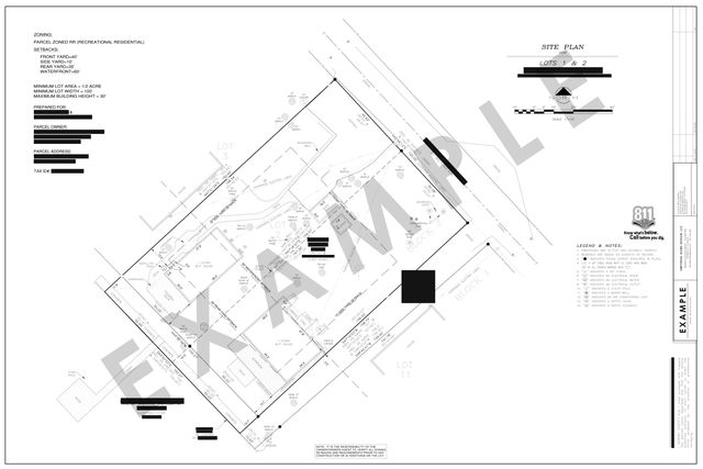 Waterfront site plan: Two cottages on two lots, with a deck to the water and setbacks.
